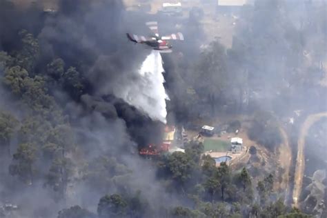 Homes feared destroyed by wildfire burning out of control on Australian city of Perth’s fringe